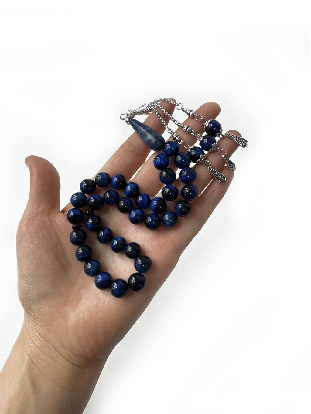 Close-up of blue tiger eye prayer beads with deep blue reflective hues