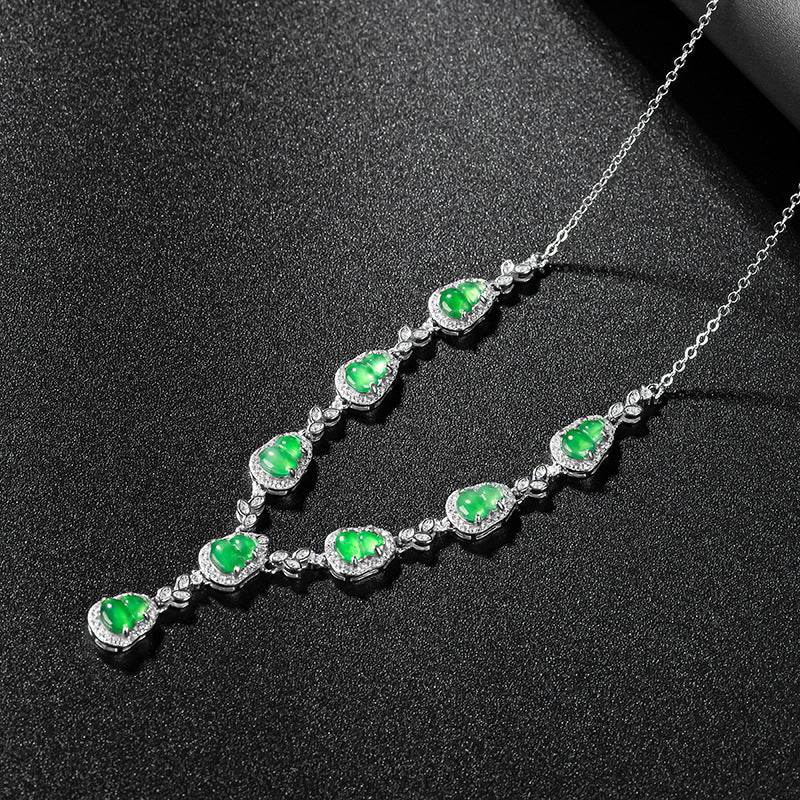 Close-up of green jade stones set in platinum-plated silver necklace