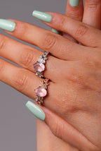 Close-up of soft pink crystal ring in platinum setting