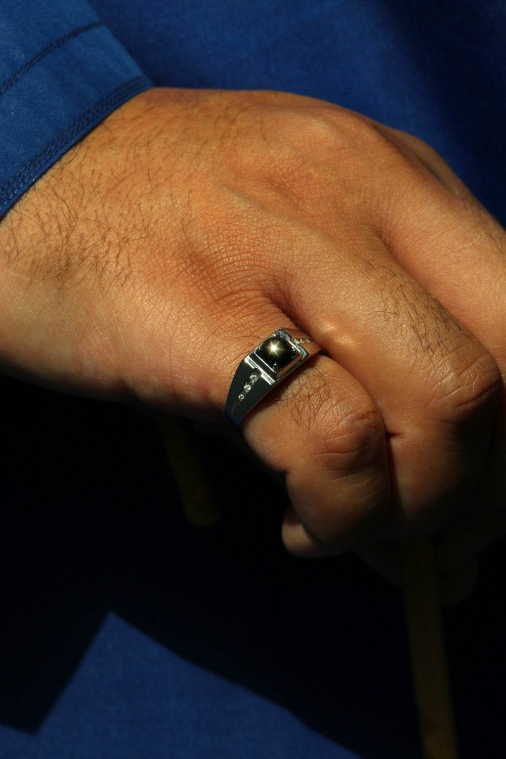 Modern celestial-inspired men’s ring with natural star sapphire
