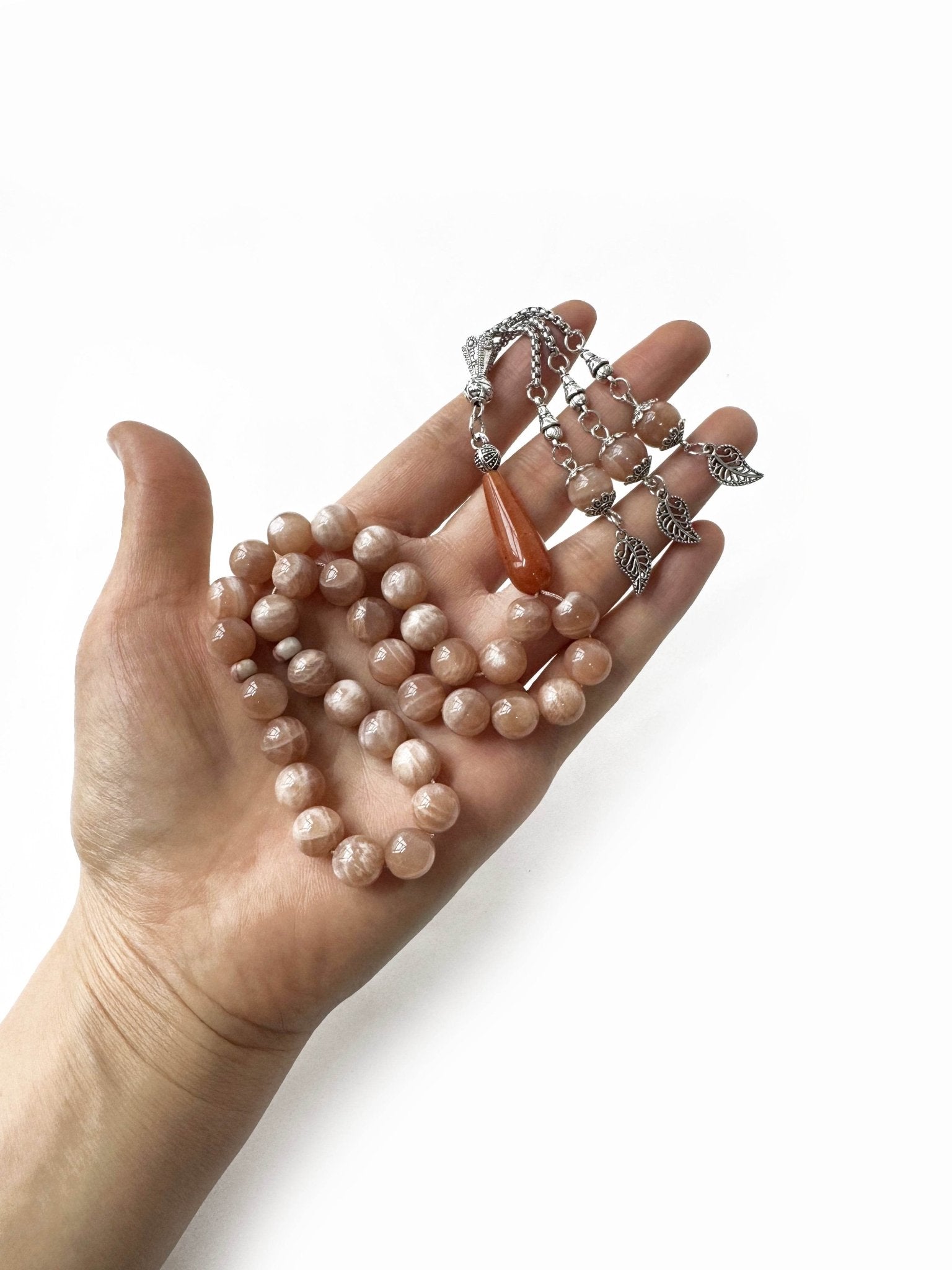 Close-up of shimmering sunstone beads used in elegant Islamic prayer tasbih