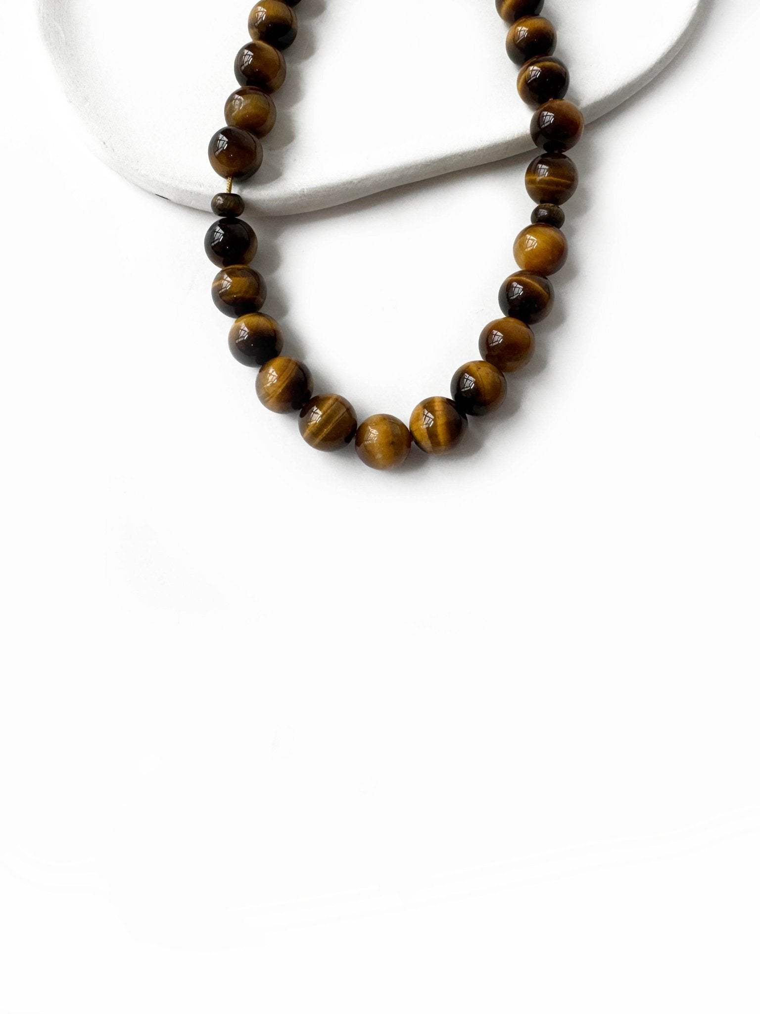 Earth-toned tiger eye beads in Islamic prayer misbaha design