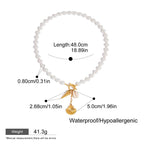 Pearl bracelet with gold charm and measurement details on a white background
