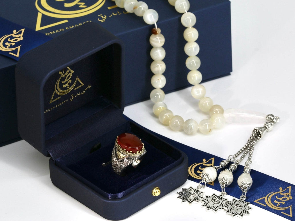 Close-up of red agate ring for men with engraved silver patterns