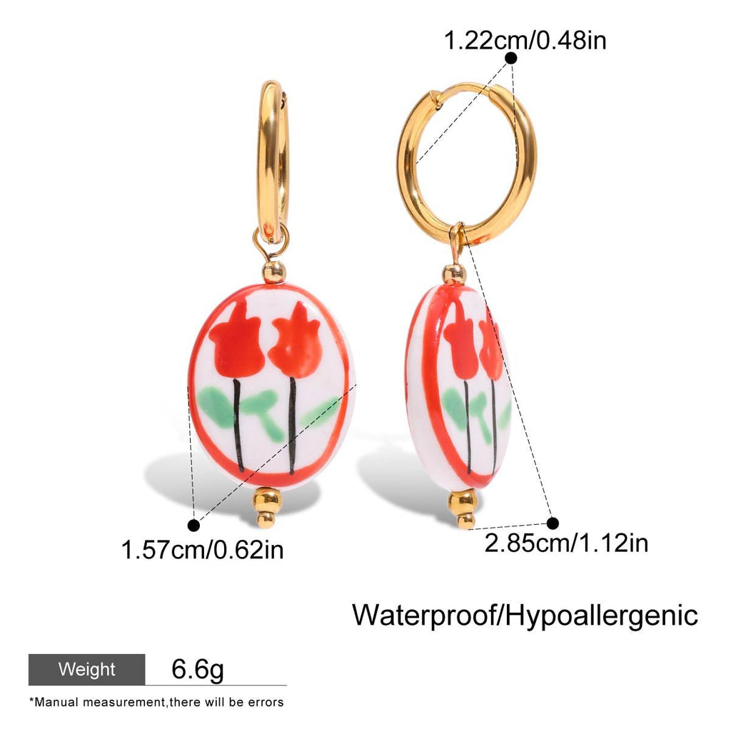 Floral earrings with gold hooks and measurements on a white background