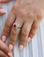 Rhodium-plated silver ring featuring bold ruby zirconia center