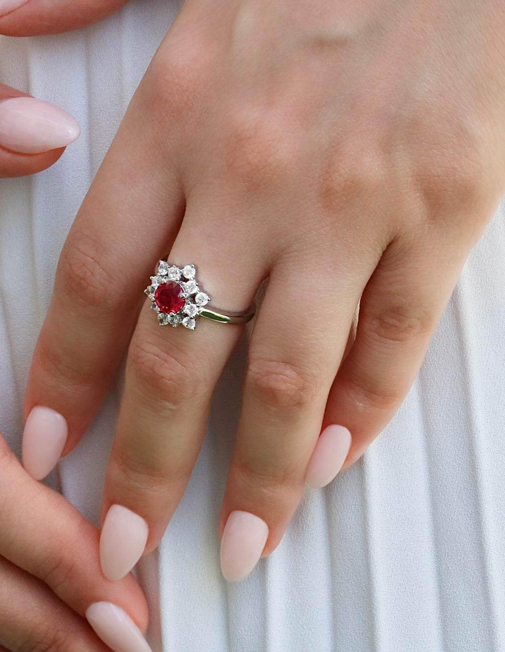Rhodium-plated silver ring featuring bold ruby zirconia center