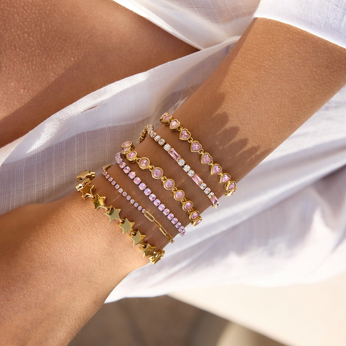 Soft-toned silver bracelet with pink round stones