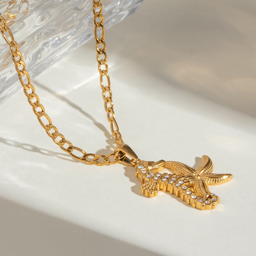 Gold necklace with a crocodile-shaped pendant on a light background
