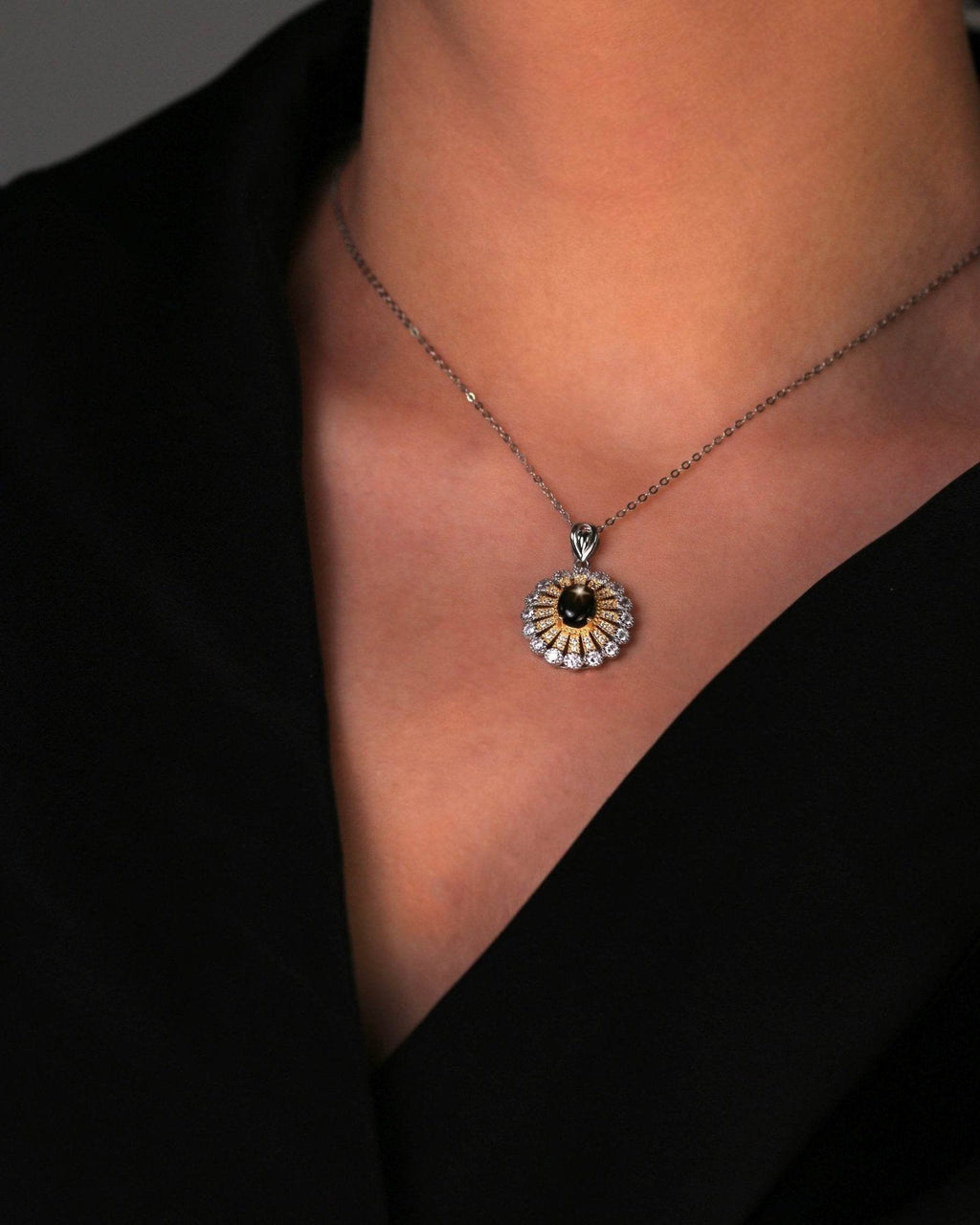 Close-up of handcrafted star sapphire necklace in gold-plated silver