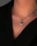 Close-up of handcrafted star sapphire necklace in gold-plated silver