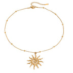 Gold necklace with a sun-shaped pendant on a white background