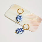 Pair of earrings with floral design on a white background