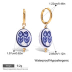 Pair of earrings with floral design, gold hooks, and measurements on a white background.