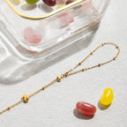 Gold chain with small stones on a light surface