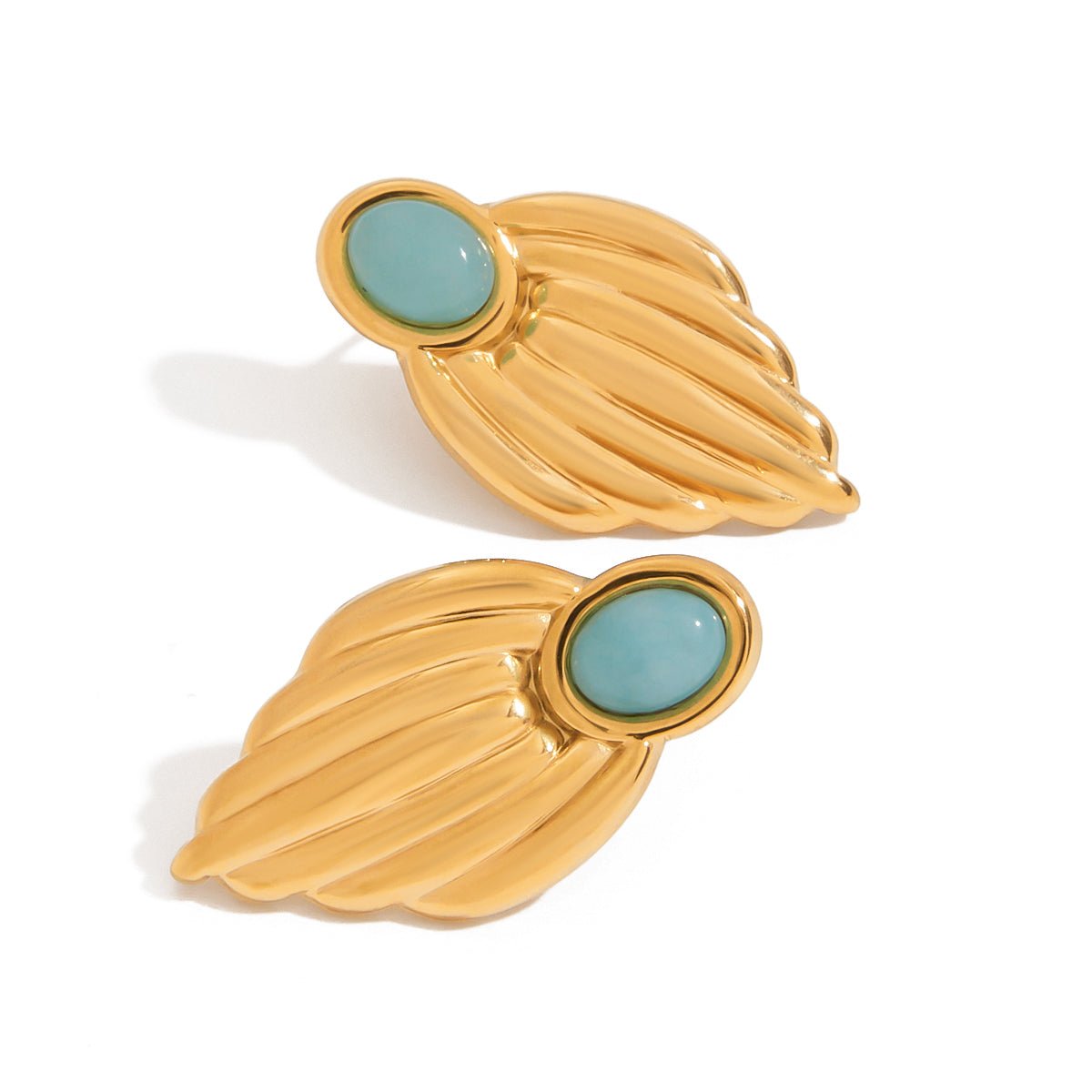 Gold leaf-shaped earrings with turquoise centers on a white background