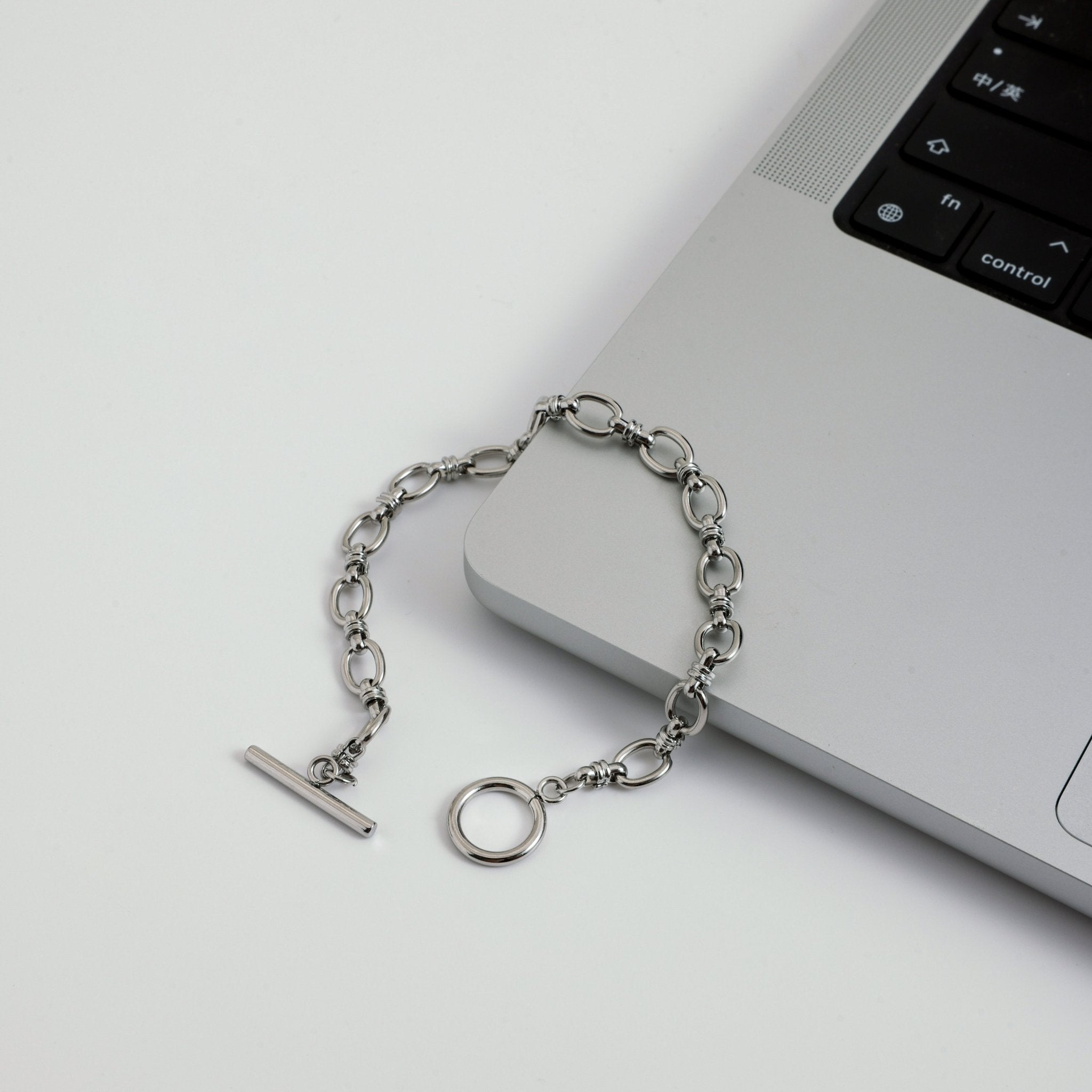 Silver chain bracelet on a laptop keyboard