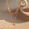Gold necklace with a pendant on a textured surface